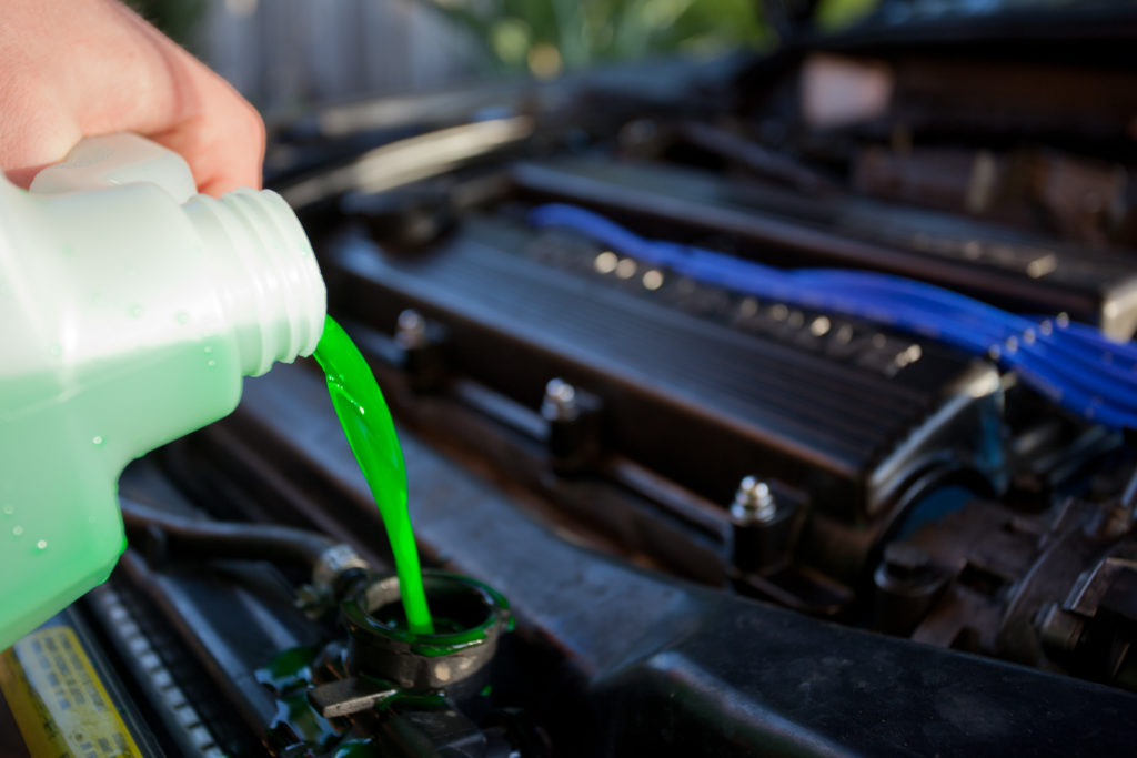 Mechanic refilling engine coolant fluid