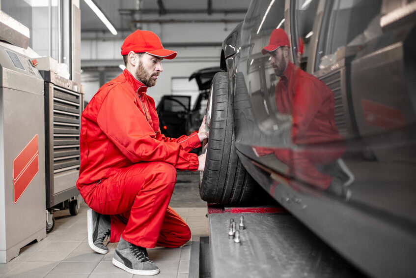 man changing wheels at the car service man changing wheels at the car service